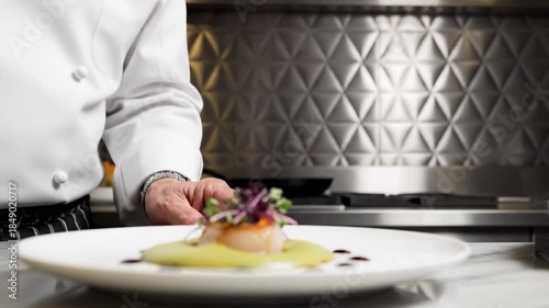 Expert hands carefully plating gourmet seafood dish with precision
