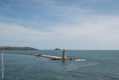 breakwater and lighthouse in Plymouth sound, England UK. granite tower beacon prominent national heritage landmark building in bay on English channel coastline.  