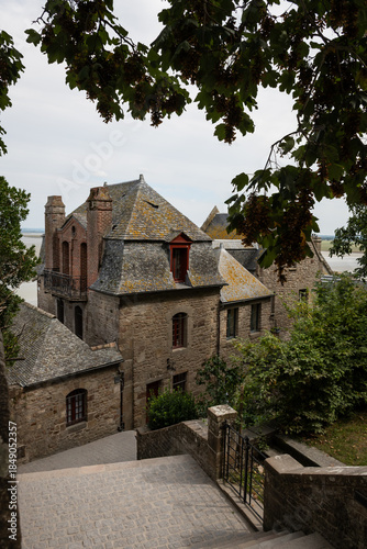 quiet empty ancient historic streets around medieval abbey  Mont Saint-Michelon tidal island in Normandy France. popular landmark attraction destination for cultural excursion