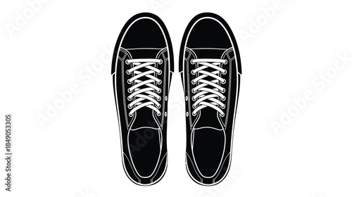 A top down view of a pair of black and white canvas sneakers