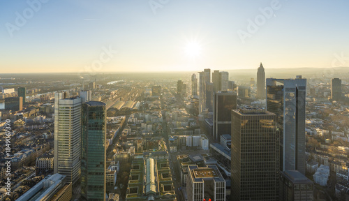 Aerial view of skyscrapers piercing the skyline, bathed in the golden light of the setting sun, a mesmerizing urban panorama., Frankfurt am Main, Hessen, Germany.