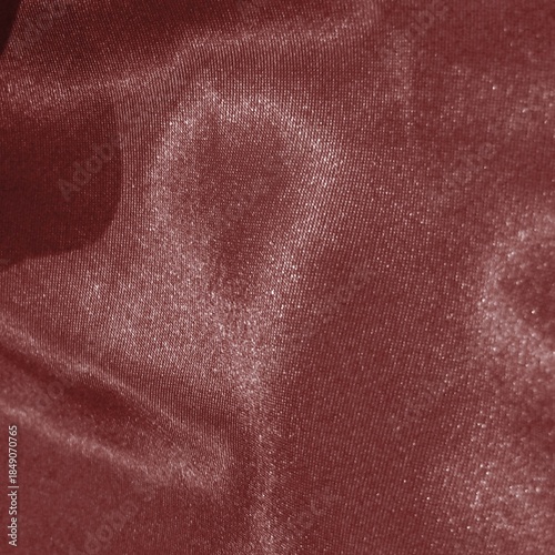 Shiny red satin fabric texture, sparkling folds, glamorous metallic silk background ideal for luxury branding, fashion, holiday themes, packaging.