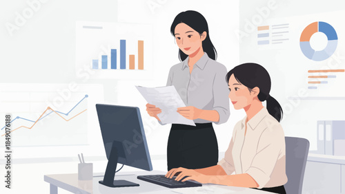 Two women working in an office with data charts