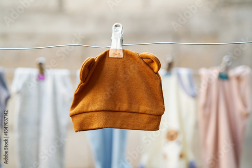 Baby hat hanging on a clothesline