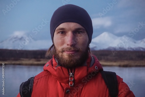A Man on a Frozen Lake with a View of Kamchatka Volcanoes