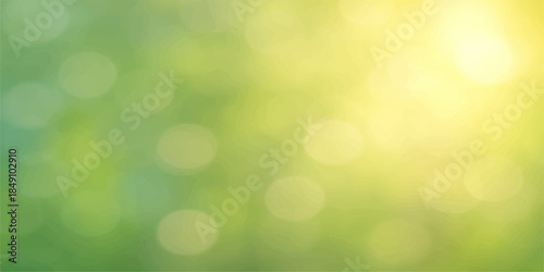 A glowing green abstract bokeh background features bright defocused light circles and a shiny blurred nature pattern creating a festive decorative effect for a spring or summer backdrop