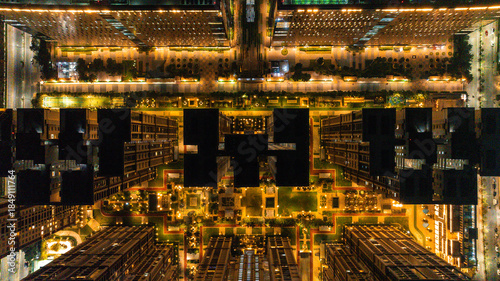 Aerial view of illuminated buildings and streets casting a warm glow over the city at night, creating a mesmerizing urban landscape, Hyderabad, Telangana, India.