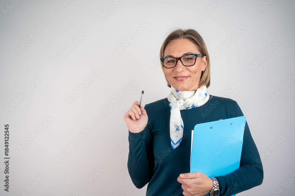 © Nenad - Photo of gorgeous blond secretary woman writing notes on clipboard in office © Nenad - Photo of gorgeous blond secretary woman writing notes on clipboard in office