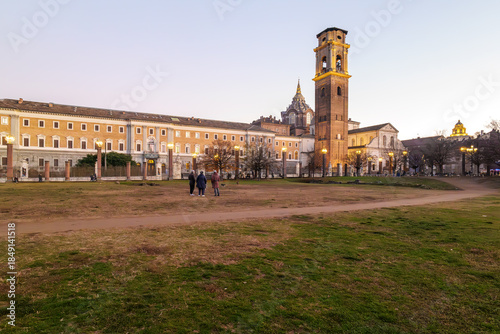 Turin, Italy. Panoramic view from the Palatine Towers Archaeological Park showing the bell tower and dome of the Basilica of Turin, the Chapel of the Holy Shroud and historic museums at dusk.