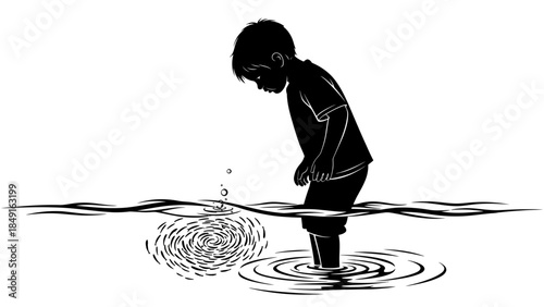 Contemplative young boy standing in shallow water casting a small ripple with a thoughtful posture