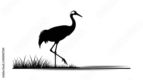 Minimalist black and white silhouette of a heron standing in wet grassy terrain by a waterbody