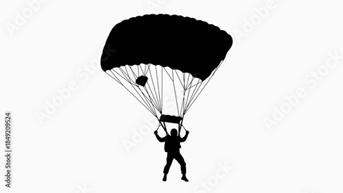 Silhouette of a skydiver parachuting with open parachute