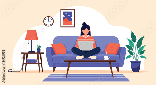 Woman working or studying on her laptop while sitting cross-legged on a sofa in a comfortable and modern living room.