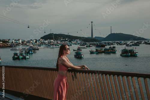 A young woman stands against the background of the Hon Thom Ropeway