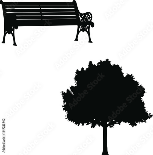 Silhouette of a park bench and a leafy tree below