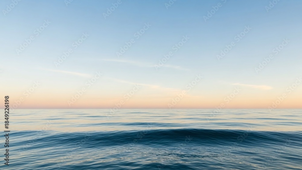 Obraz premium Calm Ocean Waves at Sunset with Clear Blue Sky and Soft Horizon Glow