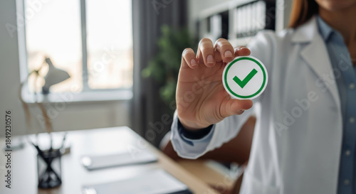 Doctor holding green check mark symbol for medical approval, health insurance and successful test