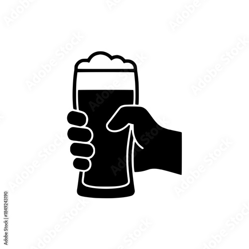 Hand holding a glass of beer with foam