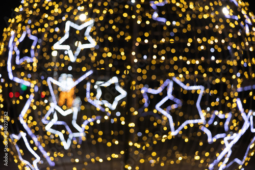 Defocused festive Christmas and new year's eve background with lots of bokeh and stars. 