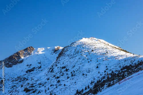 Snow-capped mountain peak under a clear blue sky. The Chleb peak in The Mala Fatra national park, Slovakia, Europe.