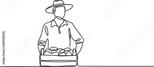 Farmer in hat with box of fresh produce