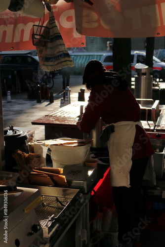 Young Woman Serving Soup at a Winter Market in Bern