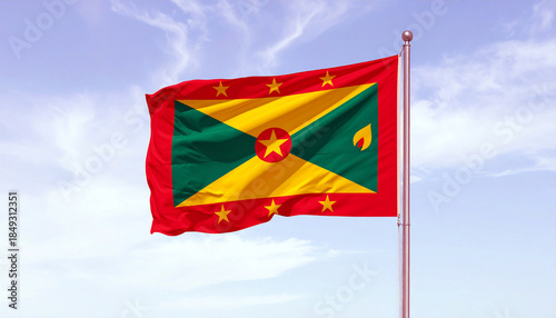 Flag of Grenada waving in the wind against blue sky