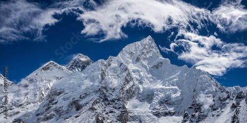 Panoramic view of the highest mountains in the world, Mahalangur Himal from Kala Patthar slope. Cirrus clouds over high snowy mountain ridge with Mt. Everest.