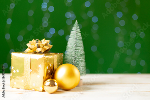 Christmas gift box on table against bokeh background