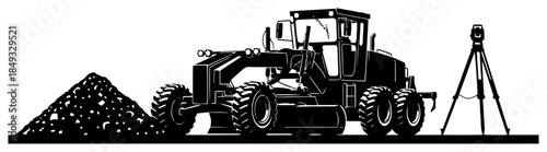Heavy motor grader working on road construction site with surveyor tripod