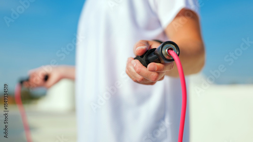 Person skipping rope on a clear day outdoors