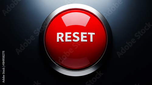 Extreme close up of a glossy red emergency reset button with metallic silver trim against dark background