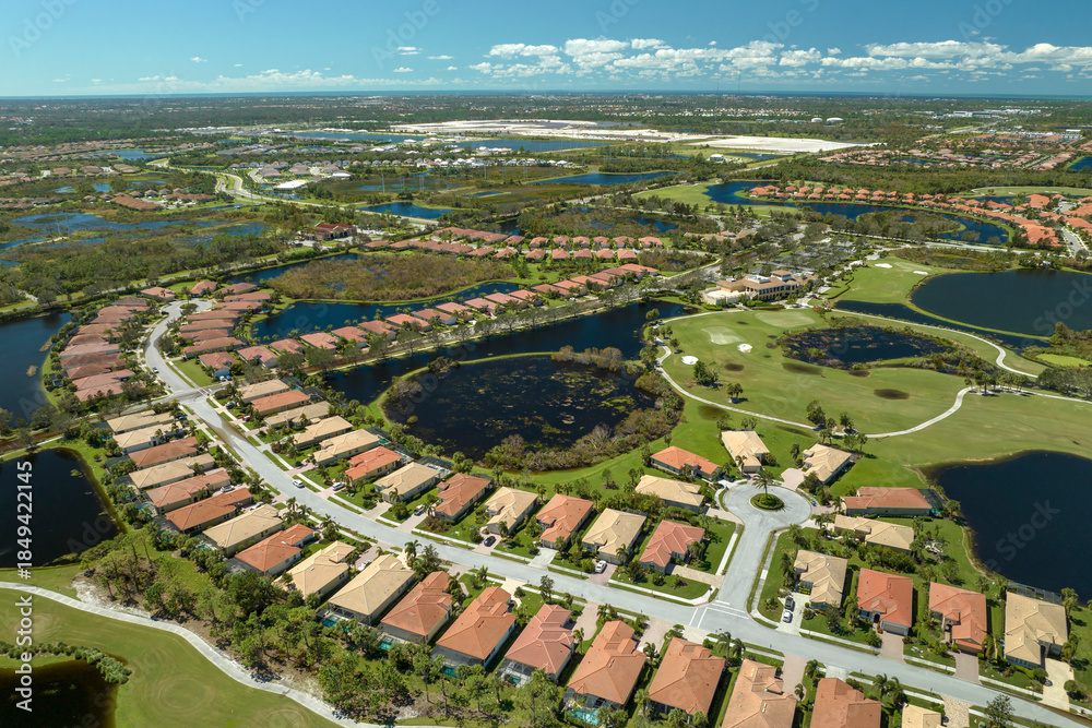 Fototapeta premium Aftermath of natural disaster. Surrounded by hurricane Ian rainfall flood waters homes in Florida residential area