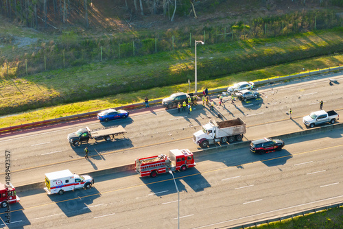 Fotografie Severe car crash with first responders helping at accident site on American highway