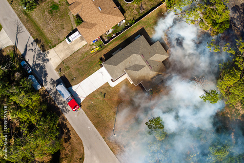Fotografía Vegetation fire burns jungle forest near Florida houses as firefighters and fire
