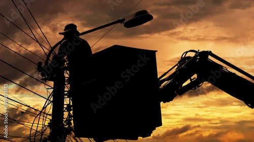 Silhouette of an electrician to repair street lighting
