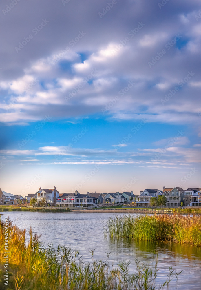 Obraz premium Homes along shimmering man made lake in Daybreak