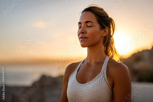 Close-up of woman's hands in gyan mudra, a yoga meditation pose, bathed in warm, golden sunlight streaming through a window.