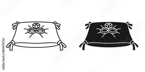Wedding rings and diamond on black and white pillows