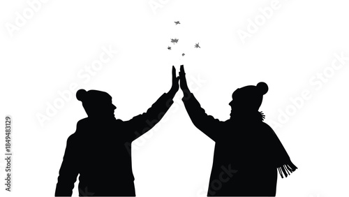 Silhouetted figures sharing a joyful high five against a bright background, celebrating togetherness.
