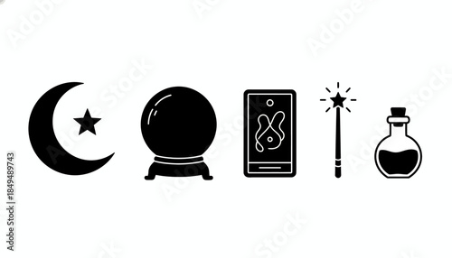Mystic objects including a crystal ball, wand, and smartphone on a table indoors