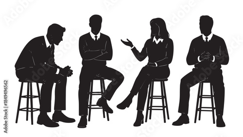 Silhouettes of professional business people engaged in a serious meeting conversation or group discussion