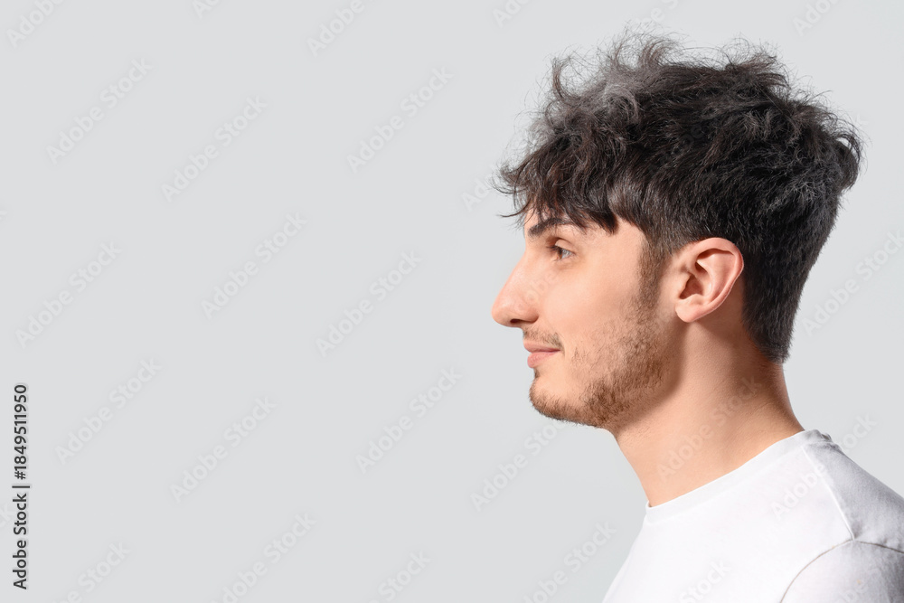 Fototapeta premium Young man with graying hair on white background, closeup
