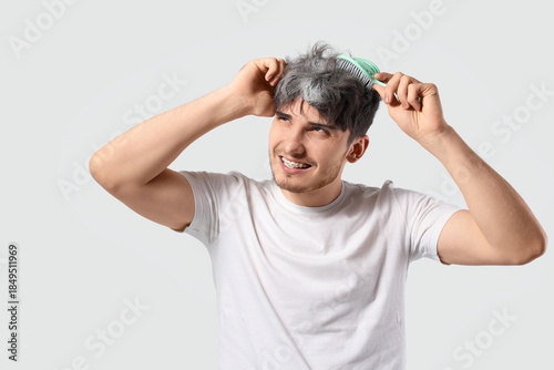 Young man brushing graying ...