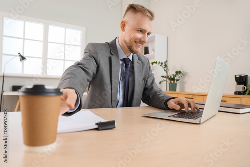 Bearded businessman with la...