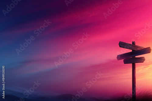 Wooden directional signpost at twilight with vibrant sky colors