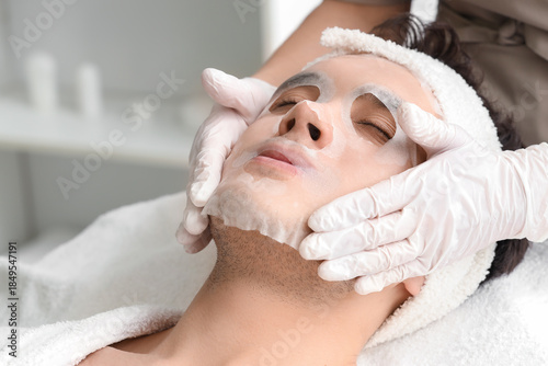 Cosmetologist applying shee...