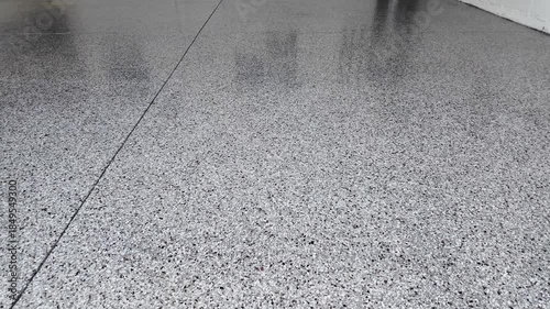 freshly coated garage, not with epoxy, but with a polyaspartic topcoat to make a garage floor look like a showroom