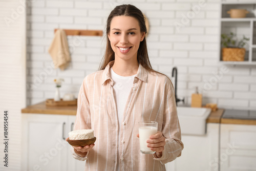 Young woman with glass of m...