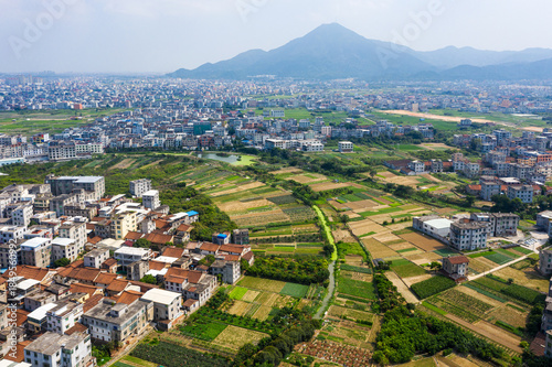 Schilderij op canvas Aerial Countryside and Farmland Surrounding Modern Asian City with Mountain